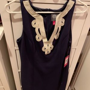 Navy blue just above the knee length fitted dress.